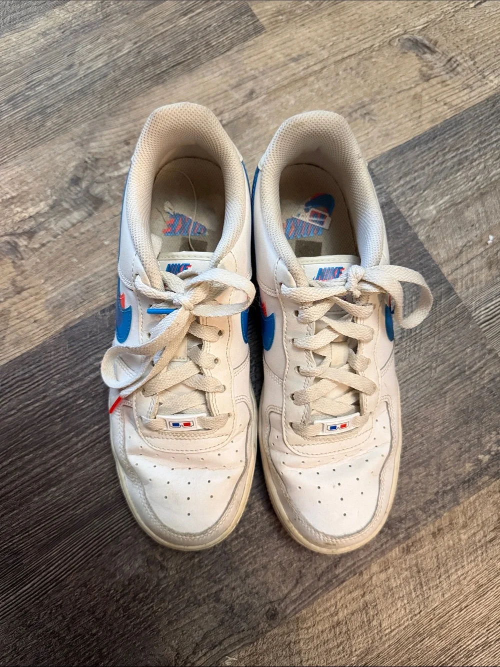 Nike White Low-Top Sneakers with Blue and Red Swoosh